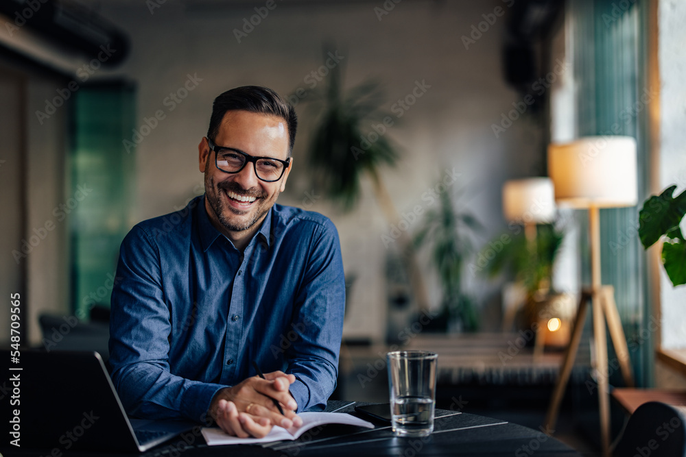 Happy male boss looking and smiling at the camera, being at the workplace. Happy male boss looking and smiling at the camera, being at the workplace.