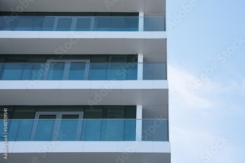 Exterior of residential building with balconies, low angle view