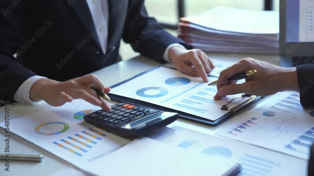 Businessman accountant using calculator and laptop for calculating finance on desk office. business financial accounting concept.