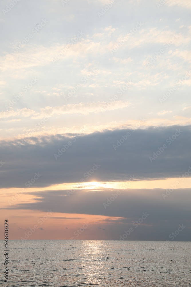 Picturesque view of sunset with beautiful clouds over sea