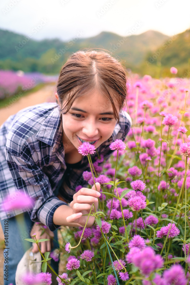 Young woman taking a walk and enjoying flowers in the garden amidst beautiful nature Thailand 20-11-2022 Young woman taking a walk and enjoying flowers in the garden amidst beautiful nature Thailand 20-11-2022