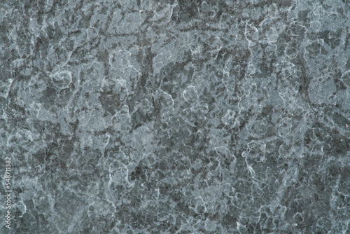 A texture of gray granite with complex pattern. Closeup