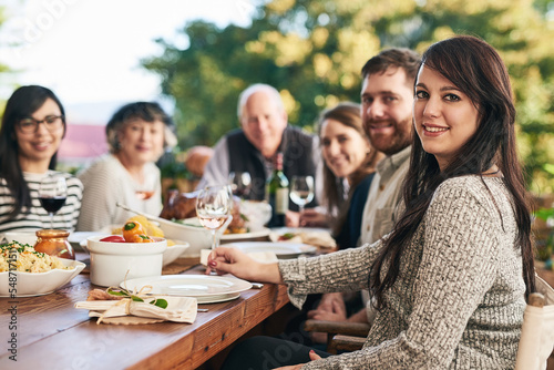 Family, dinner and party, celebrate with food and smile in portrait with holiday or anniversary together. Dinner party, happy and outdoor feast, table with men and women ready to eat and drink.