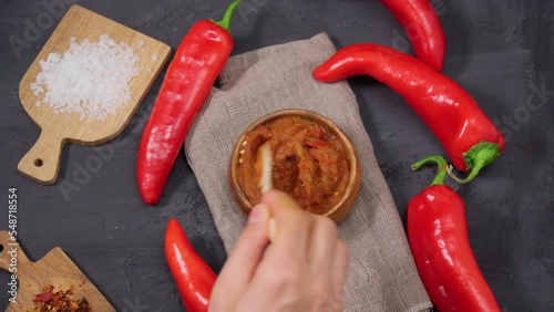 Ajvar from sweet peppers, eggplant, tomatoes, garlic and onions with spices wooden table. Balkan food. Selective focus