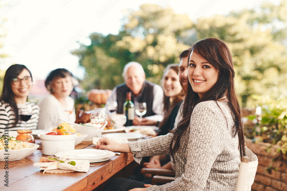 Happy woman, family and food outdoor at patio table for thanksgiving or Christmas celebration wine, alcohol and meal for dinner or lunch. Portrait of a female with friends group to celebrate holiday