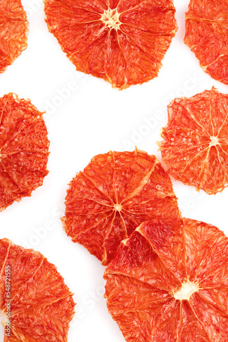 dried grapefruits and oranges in slices on a white background. Grocery background of dried citrus slices