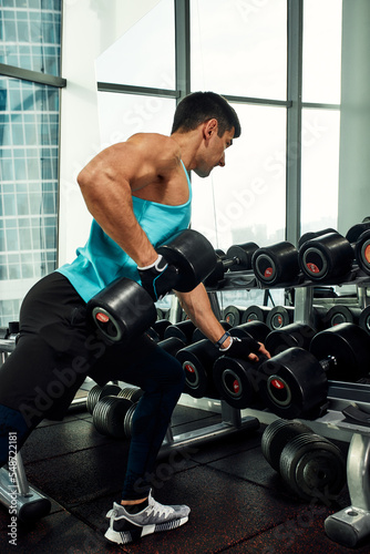 Close up of man using dumbbell exercise at gym  Sport concept