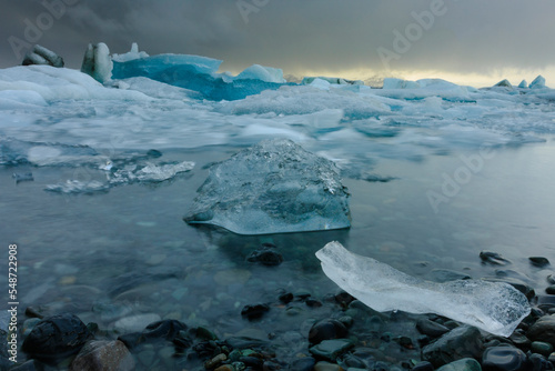 Icebergs in Jokulsarlon glacier lake at sunset 