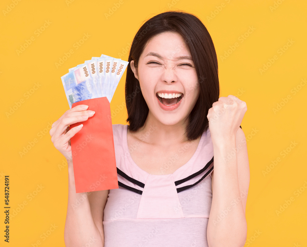 Excited young woman showing the red envelope with money