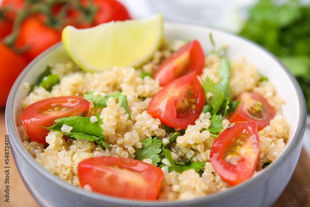 Delicious quinoa salad with tomatoes, parsley and lime, closeup Delicious quinoa salad with tomatoes, parsley and lime, closeup