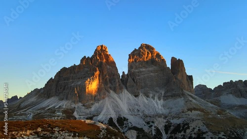 Footage filmed at Rifugio Auronzo, Tri Cine up the mountains in Italian Dolomites. Video of beautifull mountains Tri Cine, filmed at sunrise in 4k with a drone with smoooth movement photo