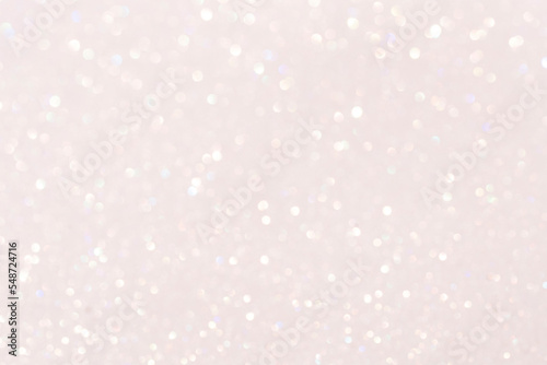 Glamorous sparkling defocused blurred festive background in light pink tones.