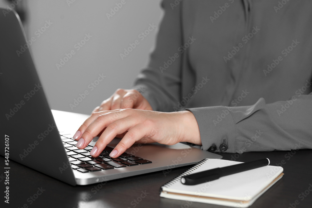Woman typing on laptop at table, closeup. Electronic document management Woman typing on laptop at table, closeup. Electronic document management