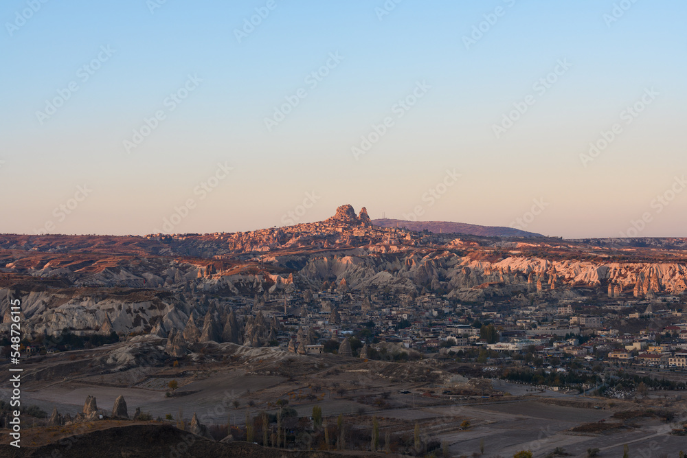 Stunning view of the village of Goreme with the Uchisar Castle in the distance during a beautiful sunrise. Cappadocia, central Antolia, Turkey.