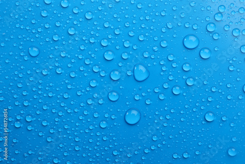 Water drops on light blue background  top view
