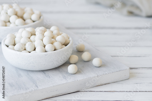 White Soy-covered Peanuts with sauce in wooden bowl, traditional turkish coated nut 