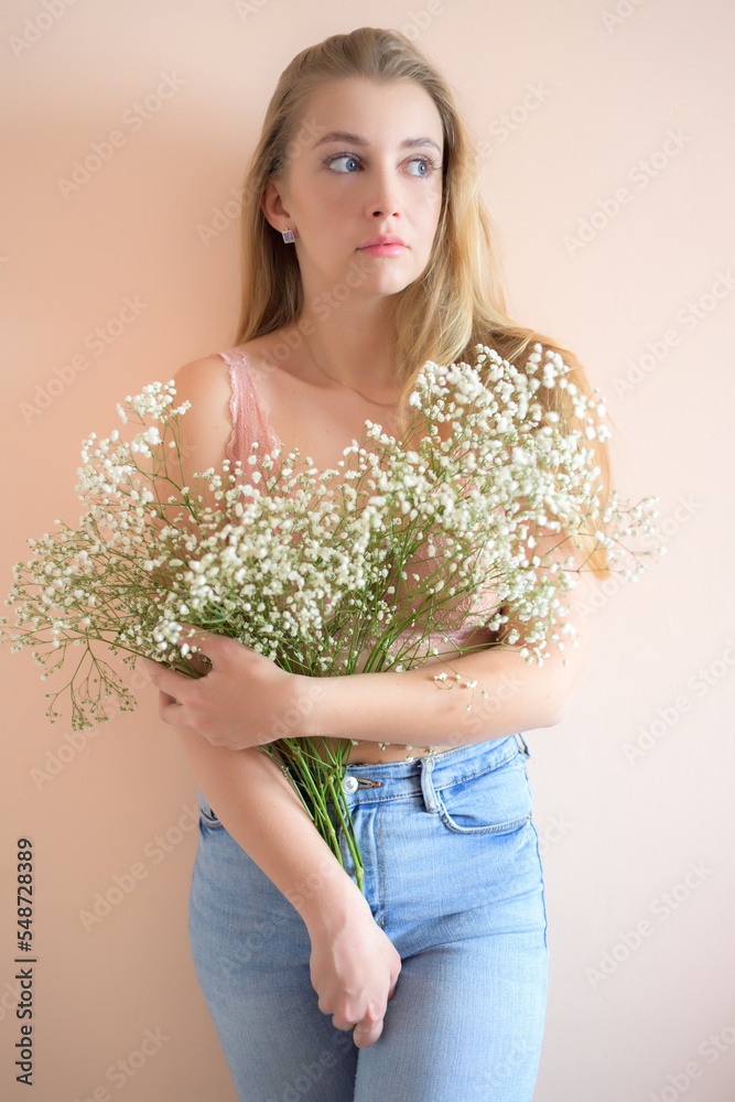 Young woman with bouquet of small flowers.