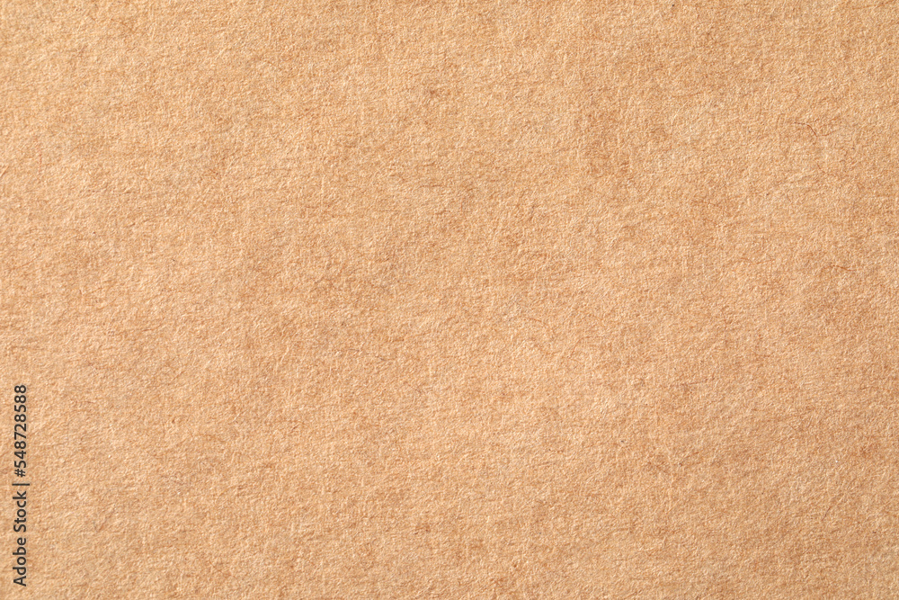 Fototapeta premium Texture of kraft paper sheet as background, closeup