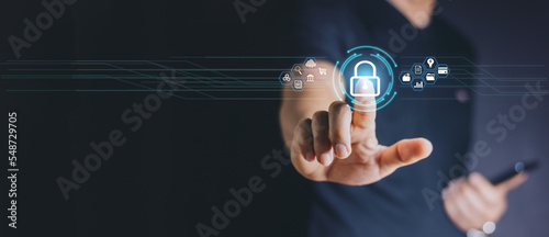 Cybersecurity and privacy concepts to protect data. Lock icon and internet network security technology. Businessman protecting personal data on smart phone with virtual screen interfaces.