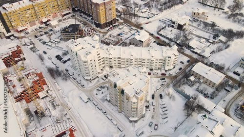 Bird's eye view of an urban residential area in winter, white snow lies. New buildings in a modern metropolis. Solution of the housing problem. City of Vladimir, Oktyabrsky district. UHD 4K. photo