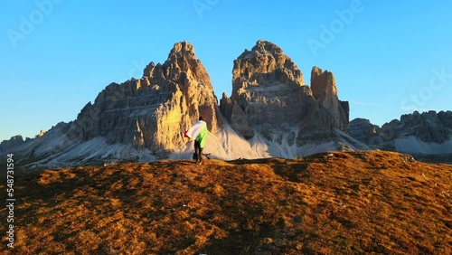 Footage filmed at Rifugio Auronzo, Tri Cine up the mountains in Italian Dolomites. Video of beautifull mountains Tri Cine, filmed at sunrise in 4k with a drone with smoooth movement photo