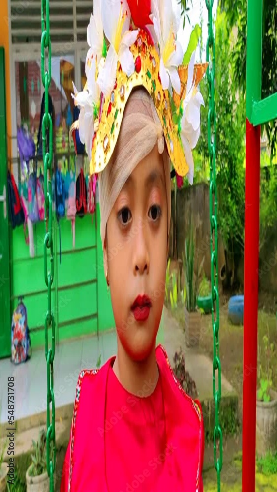 Little girl wearing bright red traditional dress cute expression in commemoration of national teacher's day