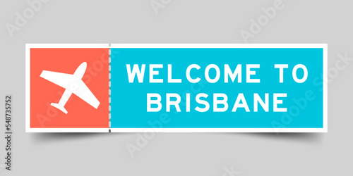 Orange and blue color ticket with plane icon and word welcome to brisbane on gray background photo