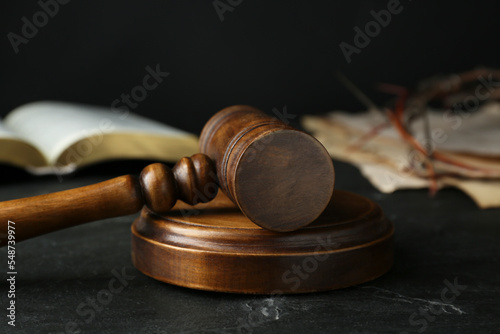 Wooden judge gavel on black table, closeup