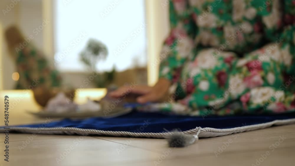 Crystal watcher hand lays out blue rug. Preparing for divination Ritual for predicting the future. Fortune telling ritual, closeup, copy space Crystal watcher hand lays out blue rug. Preparing for divination Ritual for predicting the future. Fortune telling ritual, closeup, copy space