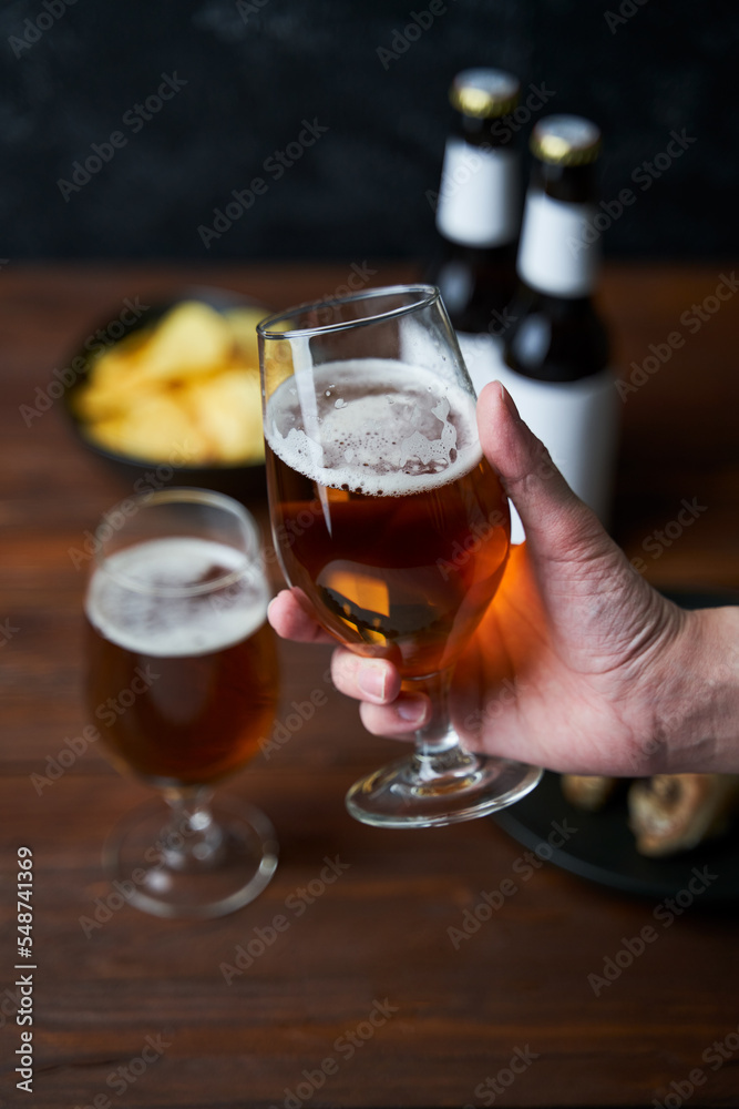 Two glasses with beer, snacks and bottles Two glasses with beer, snacks and bottles