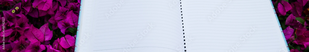 White notebook paper on the grass with copy space                              