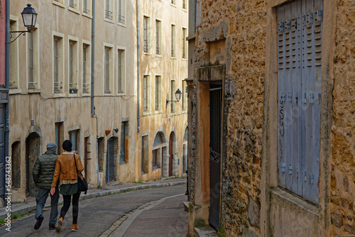 LYON, FRANCE, January 3, 2022 : Couple walking in the old streets of World Heritage district of Lyon city center
