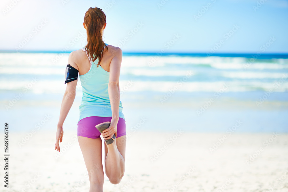 Fitness, beach and woman stretching legs in warm up for running exercise, training or cardio workout in summer. Back view, runner and sports girl with balance, peace or freedom on holiday vacation