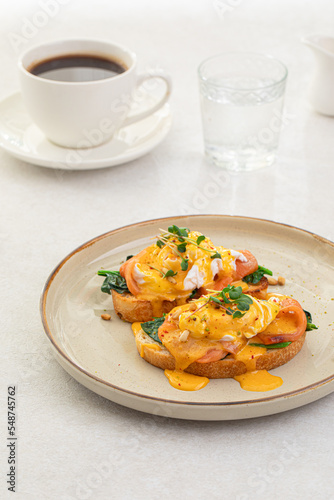 Portion of eggs benedict toast with salmon and herbs breakfast