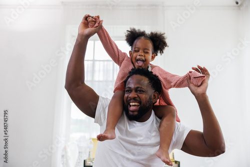 enjoy happy love black family african american father carrying daughter little african girl child smiling and having fun moments good time.  American father day concept.