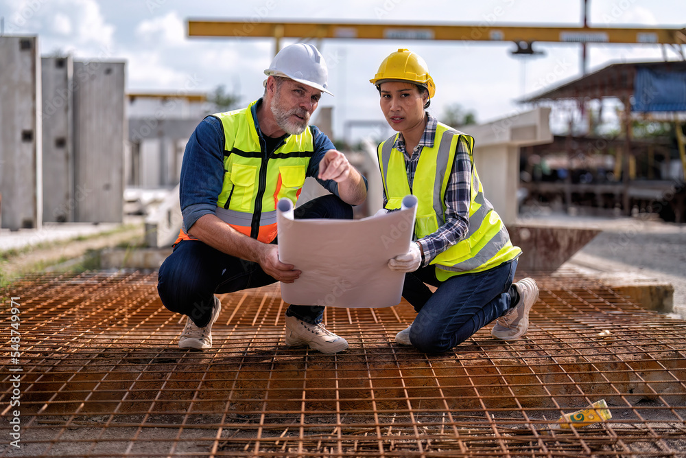 At construction site senior engineer and supervisor check steel rebar