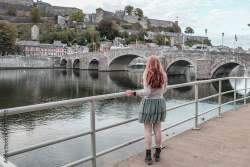 Woman staring at the view of Namur in Belgium. photo