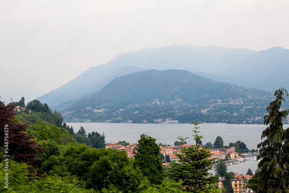 Mountain lake and city on green hills in Italy
