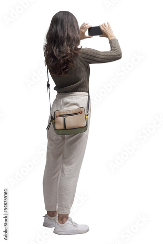Young woman taking pictures with her smartphone PNG file no background © stokkete