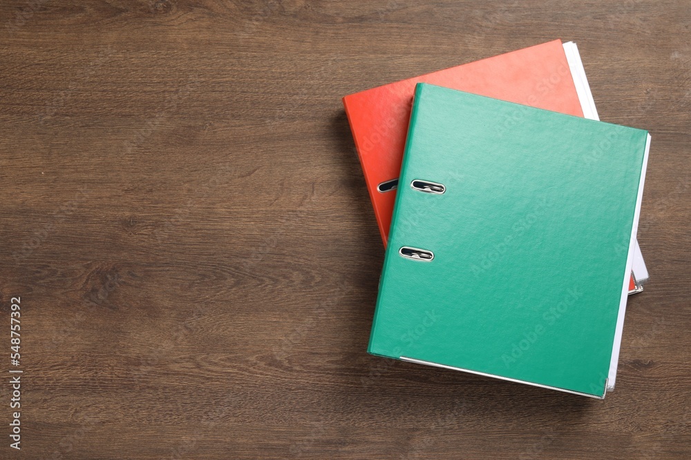 Office folders on wooden table, flat lay. Space for text Office folders on wooden table, flat lay. Space for text