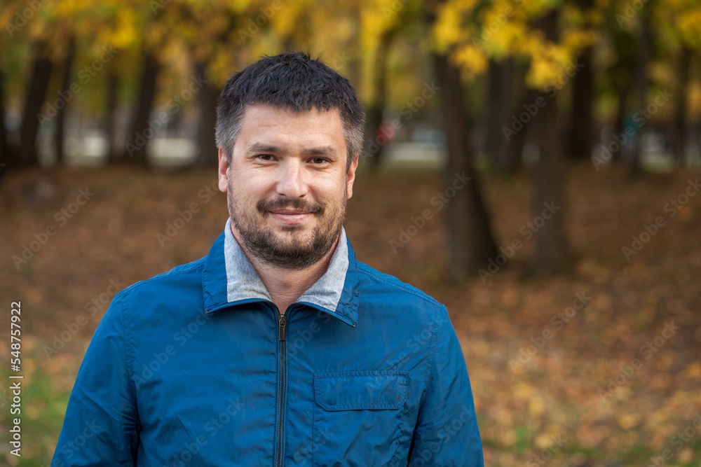 Portrait of middle-aged man in autumn park