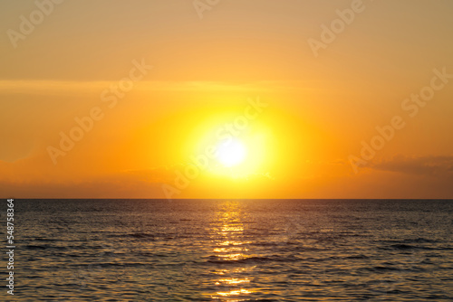 Sea sunset sky. Ocean sunrise. Sunset sky and sun through the clouds over. Meditation ocean and sky background. Tranquil seascape. horizon over the water. © pornpun