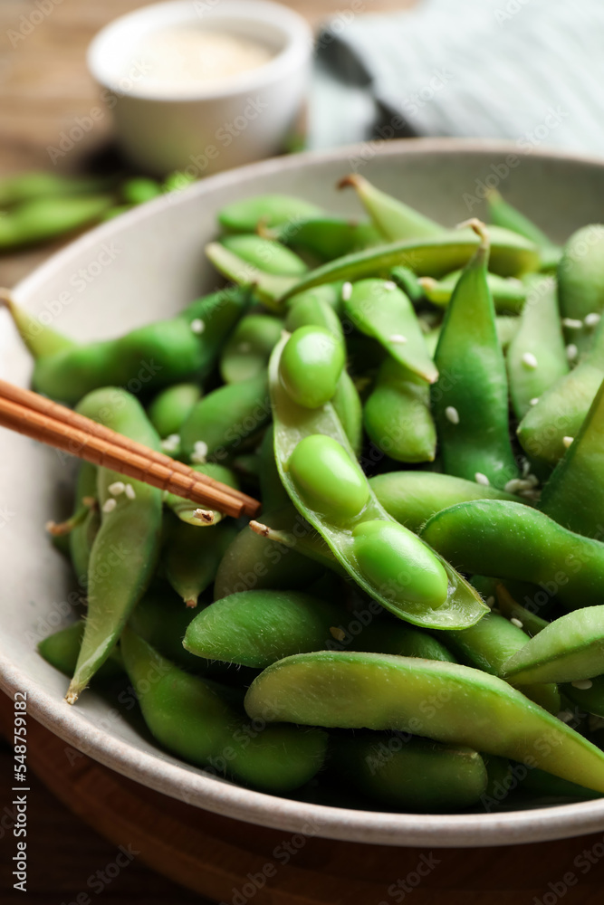 Green edamame beans in pods served on wooden table, closeup Green edamame beans in pods served on wooden table, closeup
