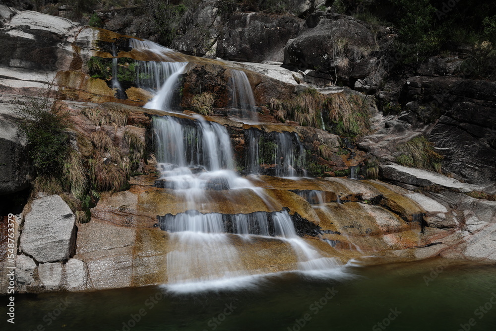 Fototapeta premium A view of the Cascata Fecha de Barjas waterfalls in the Peneda-Geres National Park in Portugal