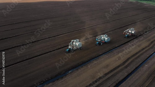 Drone shooting. Harvesting peat with combines. Peat extraction process. Agriculture industry.