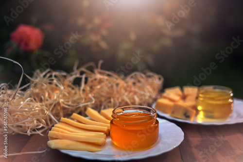 The evening sun illuminates the honey on the tablein the garden, with beautiful decoration, creative photo photo