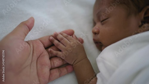 Parent hands holding newborn african black baby fingers, Close up mother's hand holding their new born baby. Together love family healthcare and medical, father's day and mother's day concept photo