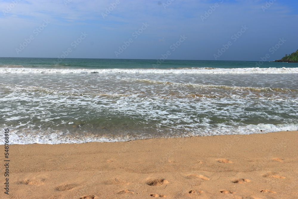 Waves on Shore of Tropical White Sand Beach on a Sunny Day