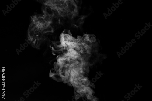 the movement of hot steam with water droplets is isolated on a black background to overlay your photos. Steam background, abstract smoke on a black background.