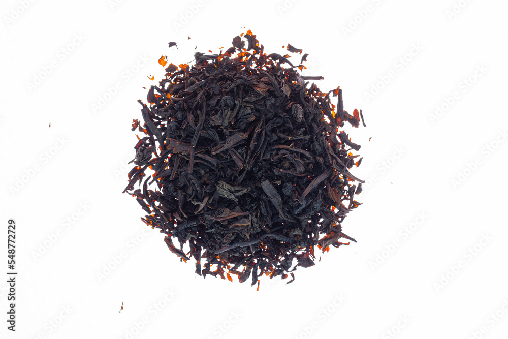 Fototapeta premium dry black tea made from flowers, herbs, leaves and berries on white paper background.